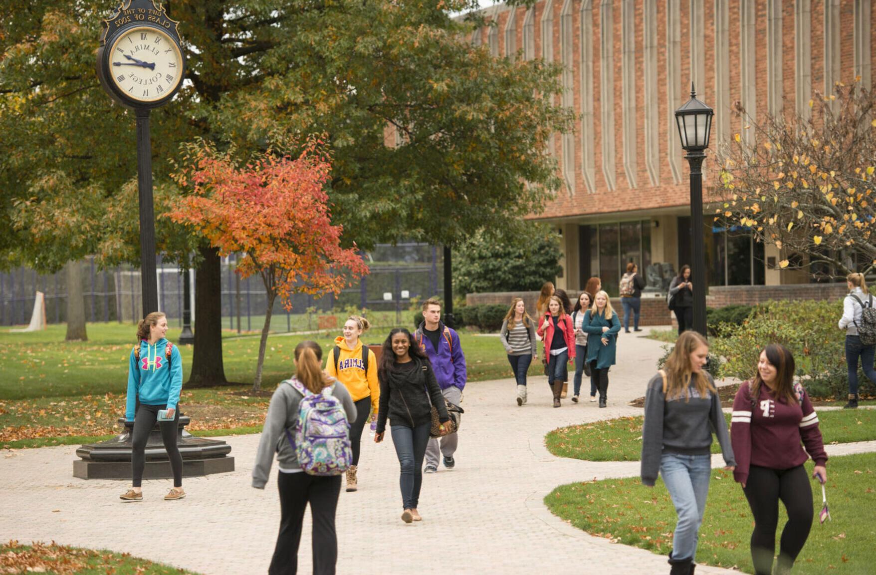 Students walk on campus during the fall